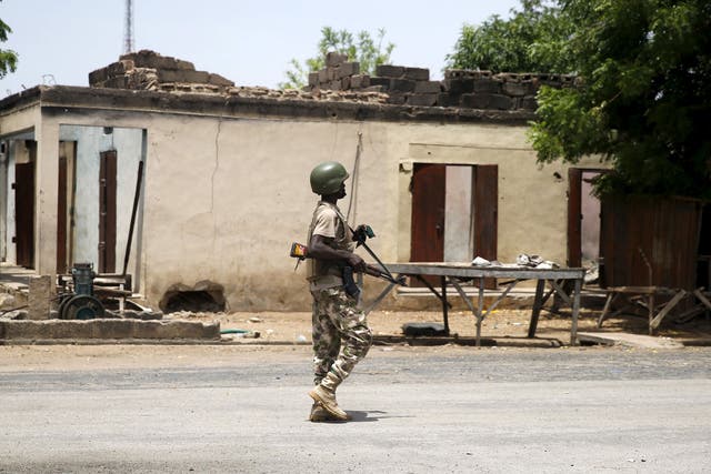A soldier walks past a burnt building in Michika town in Adamawa state in 2015 after the Nigerian military recaptured it from Boko Haram
