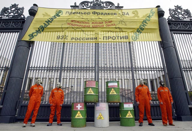 Greenpeace activists stand under a banner calling Russia the 'International Nuclear Dump' on the anniversary in 2004 of the Mayak nuclear disaster, which was shrouded in secrecy at the time