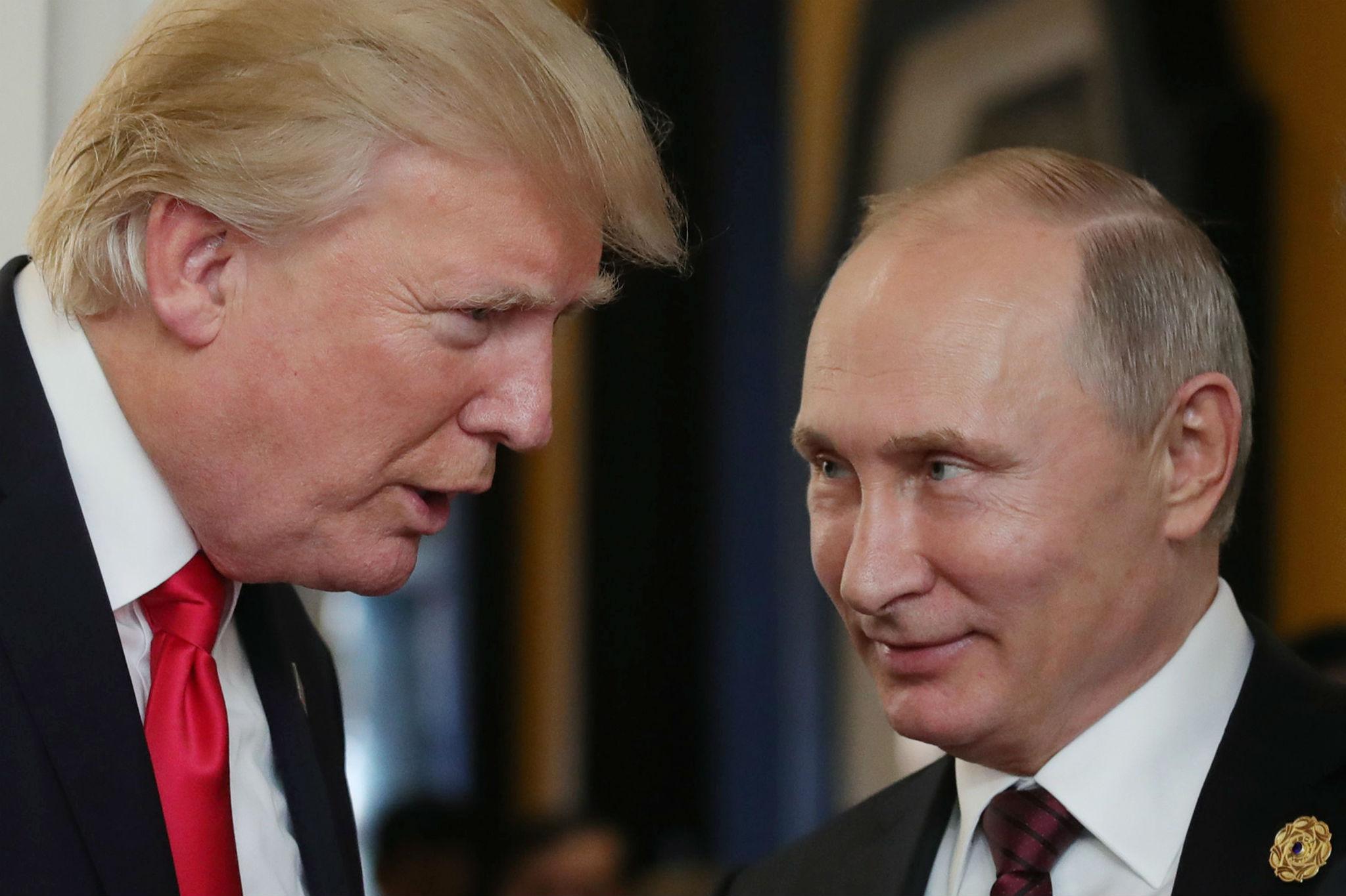 US President Donald Trump chats with Russia's President Vladimir Putin at a summit in Vietnam (MIKHAIL KLIMENTYEV/AFP/Getty Images)