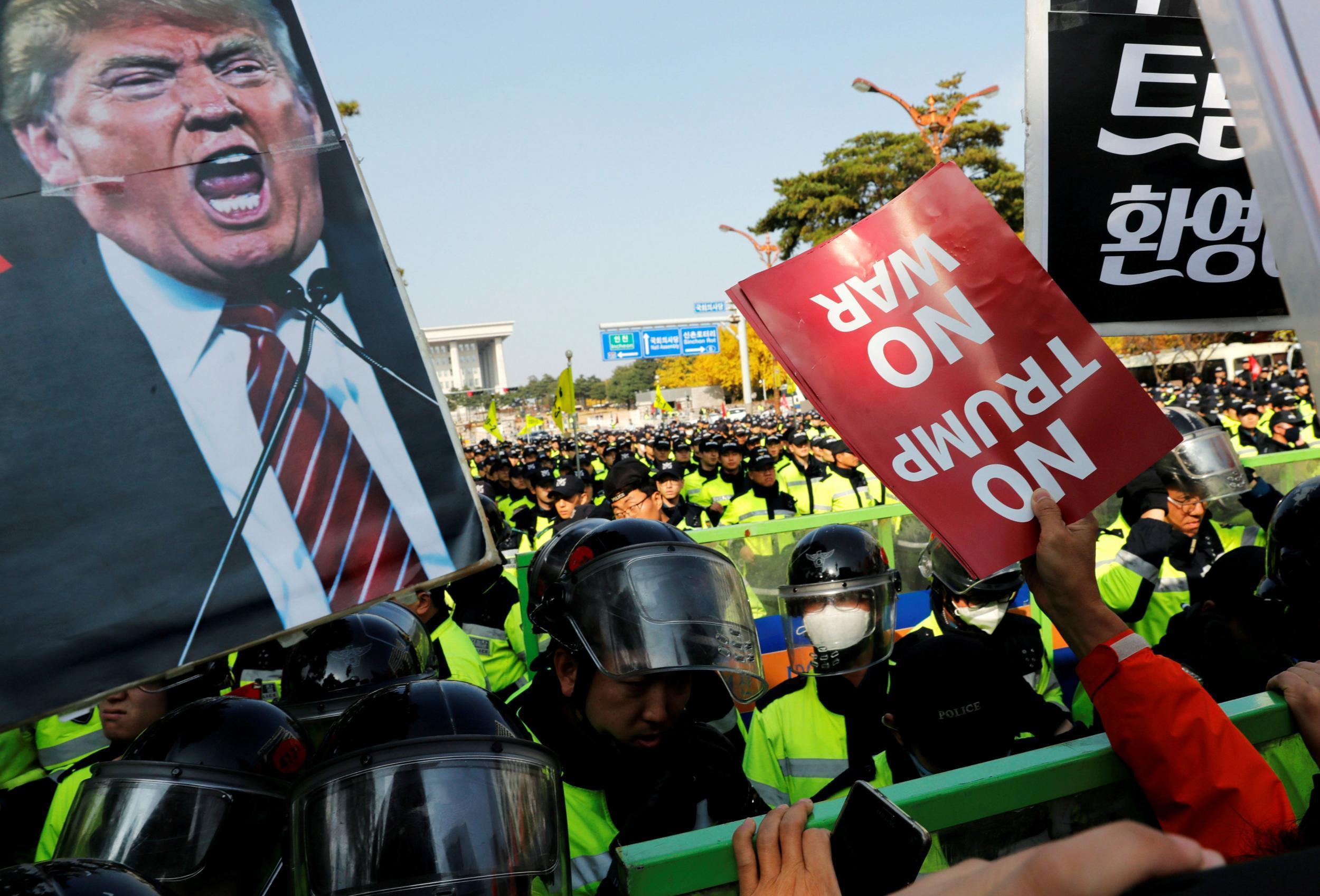 Protesters take part in an anti-Trump rally near the presidential Blue House in central Seoul, South Korea, during his visit