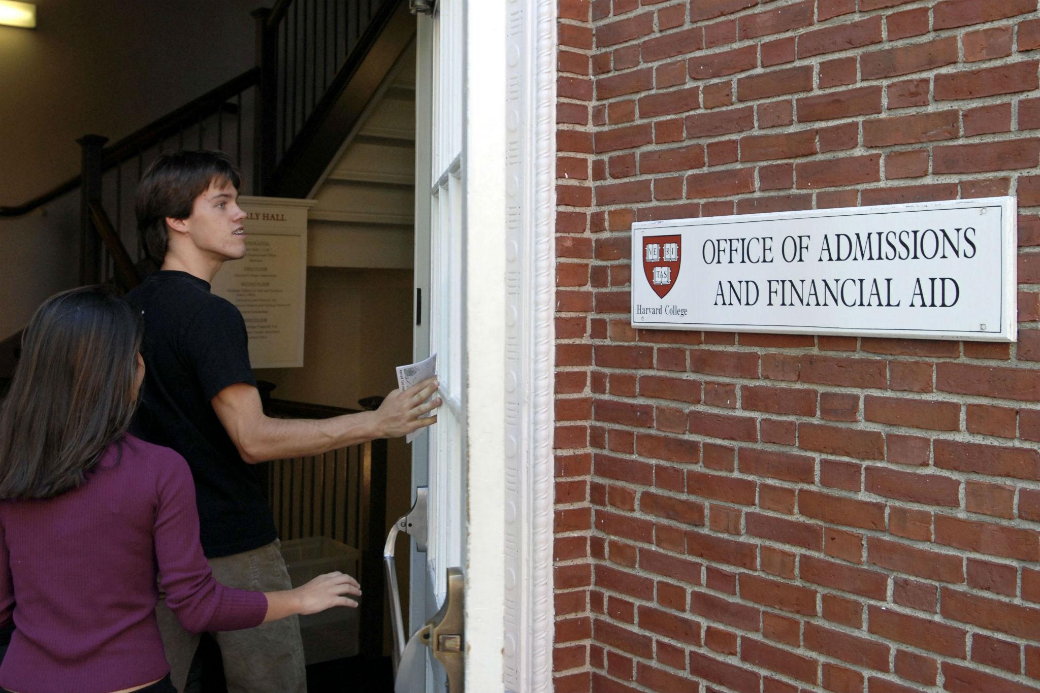 Students enter the Admissions Building on the campus of Harvard University in Cambridge, Massachusetts (Photo by Glen Cooper/Getty Images)