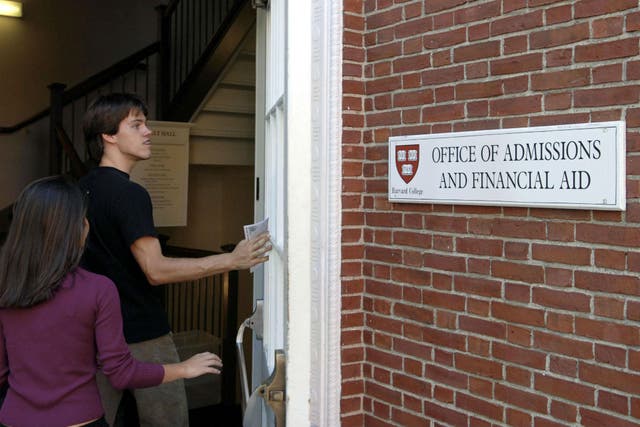  Students enter the Admissions Building on the campus of Harvard University in Cambridge, Massachusetts (Photo by Glen Cooper/Getty Images)