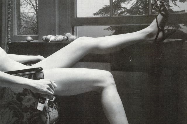 Banned advert featured black and white image of apparently naked woman wearing only a pair of strappy heels, reclining in a chair with one leg placed on top of a table and the other on the ground.