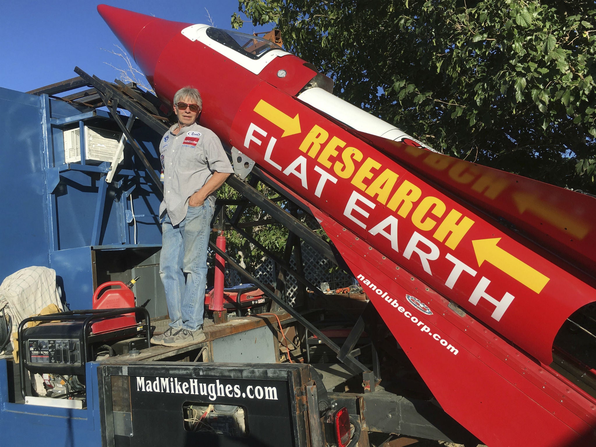 In this Wednesday, Nov. 15, 2017, photograph Mike Hughes is shown with with his steam-powered rocket constructed out of salvage parts on a five-acre property that he leases in Apple Valley, California