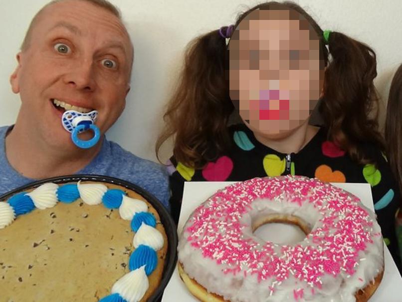 'Freak Daddy' Greg Chism with his elder daughter, both with pacifiers in their mouths