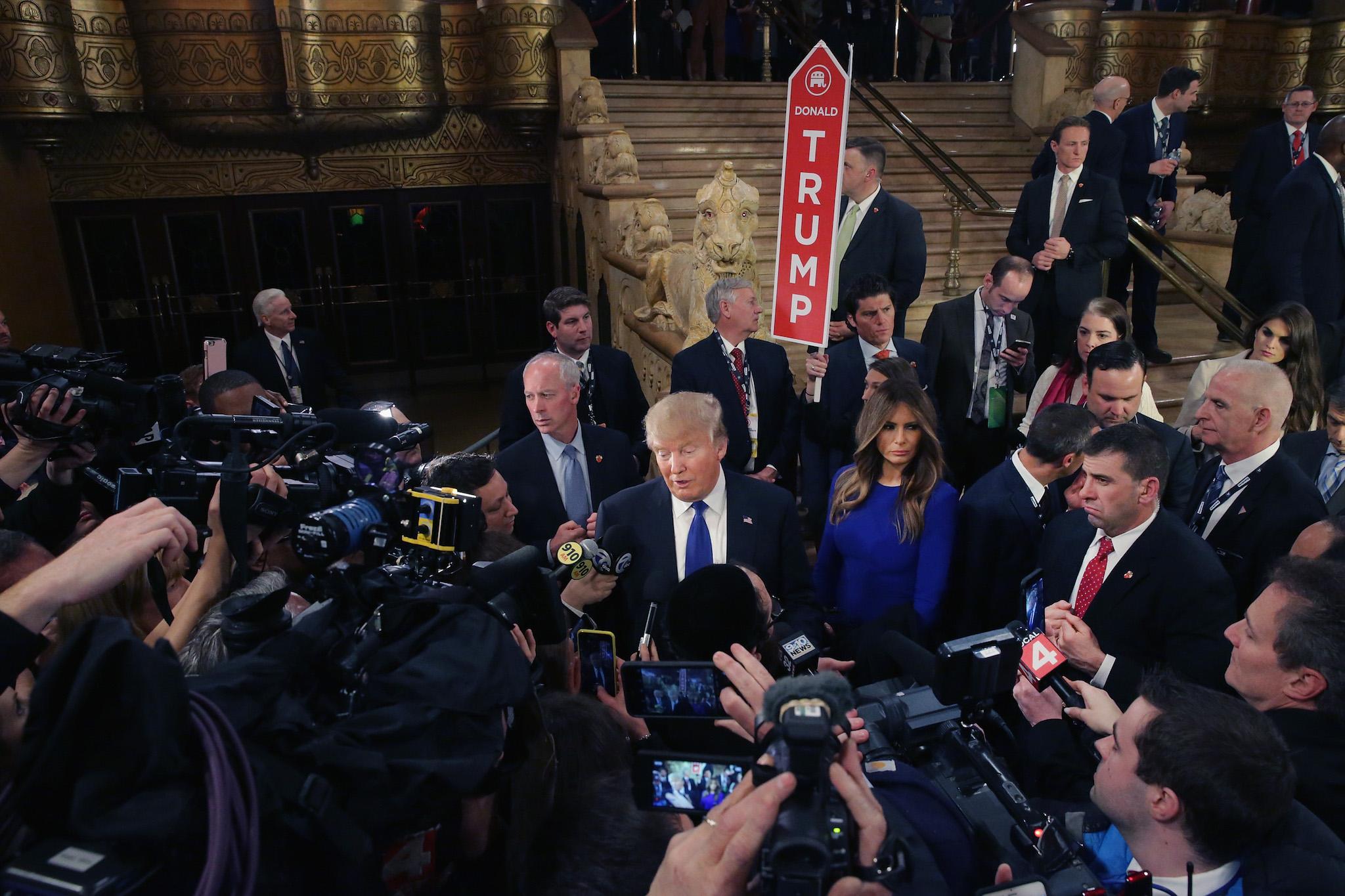 Republican presidential candidate Donald Trump greets reporters in the spin room following a debate sponsored by Fox News at the Fox Theatre on March 3, 2016 in Detroit, Michigan
