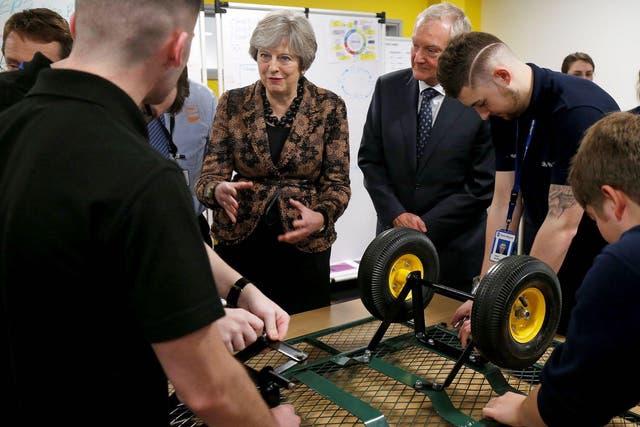 Britain's Prime Minister Theresa May visits an engineering training facility in Birmingham, central England, on November 20, 2017