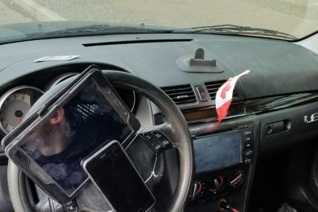 Traffic police fined a driver in Vancouver after he was found to have his phone and tablet strapped to his steering wheel.