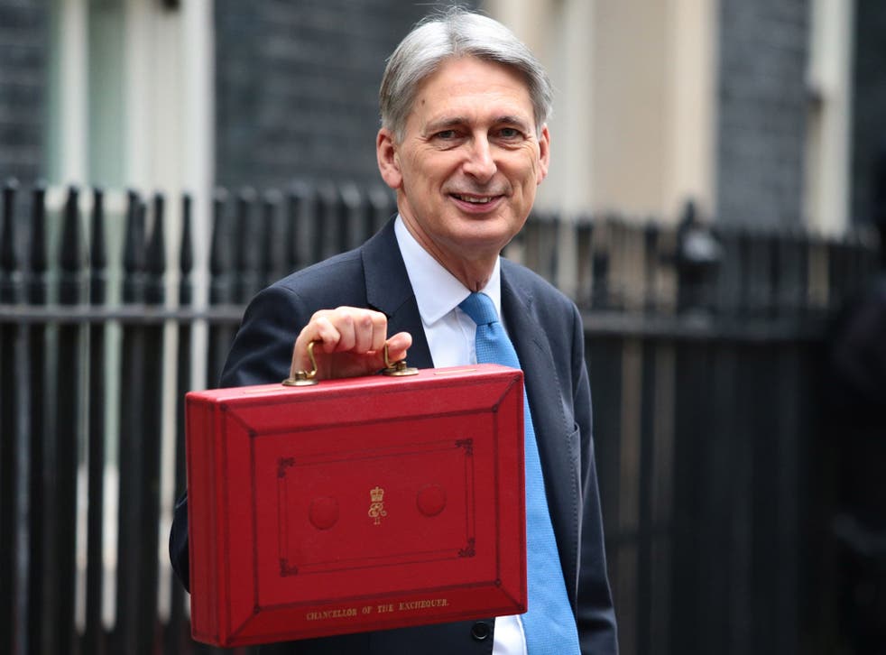 Philip Hammond holds the red case as he departs 11 Downing Street to deliver his budget