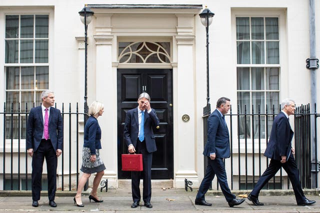 Bearing the weight: Chancellor Phillip Hammond prepares to summarise 240 complex pages 