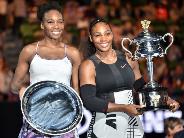 <p>Serena Williams holds the 2020 Australian Open trophy next to her sister, Venus, who she beat in the women's singles final</p>