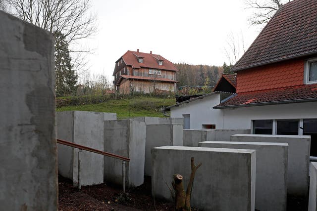 A replica of the Memorial to the Murdered Jews of Europe in Berlin, has been placed near a right wing politician's house (L)