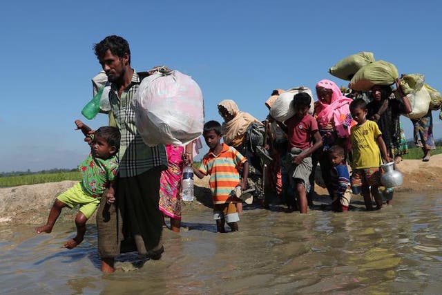 Rohingya refugees head for a camp after crossing the border in Anjuman Para near Cox's Bazar, Bangladesh
