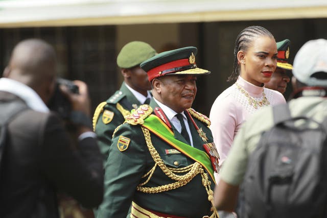 Army General Constantino Chiwenga, center, arrives with his wife Mary at the presidential inauguration ceremony of Emmerson Mnangagwa in Harare