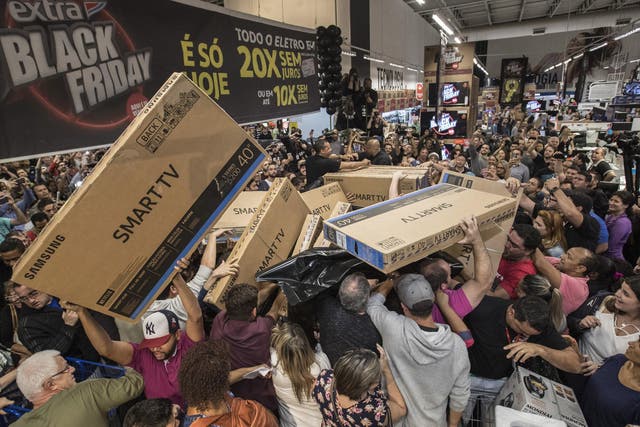 Dozens of Brazilians reach for television sets in a store in Sao Paulo, Brazil