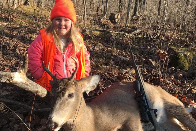 Lexie Harris, 6, poses after shooting a buck – a male deer – in Taylor County, Wisconsin