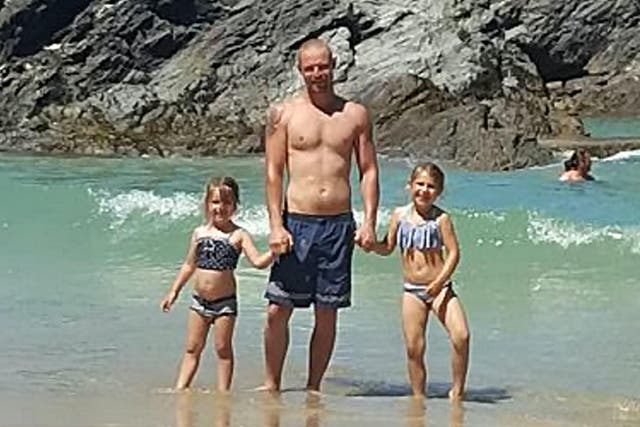 Adam Fenton with his children on the beach where he was found dead