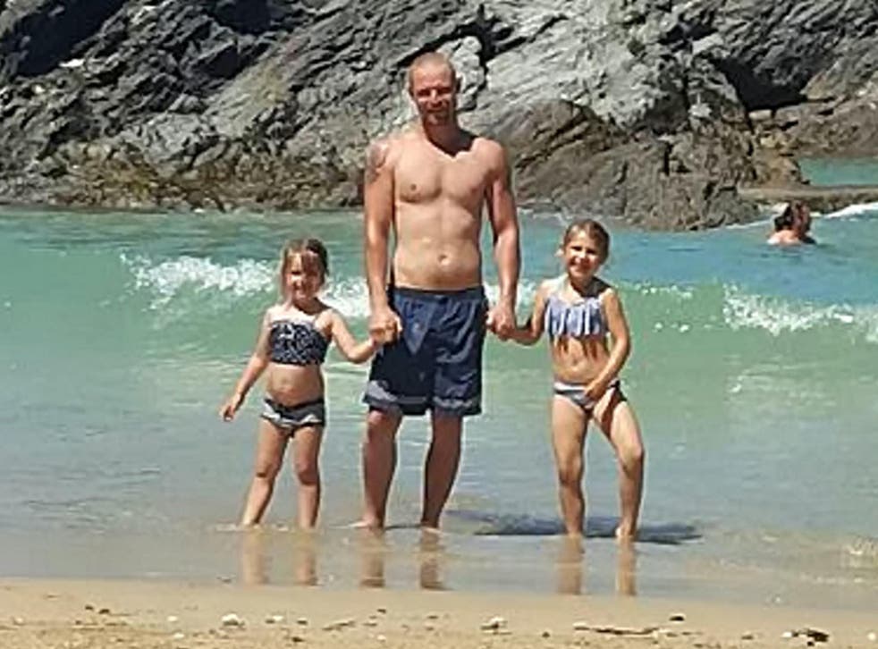 Adam Fenton with his children on the beach where he was found dead