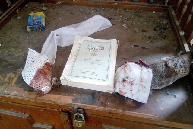  A Quran and remnants of personal belongings of victims of the attack on the al-Rawdah mosque