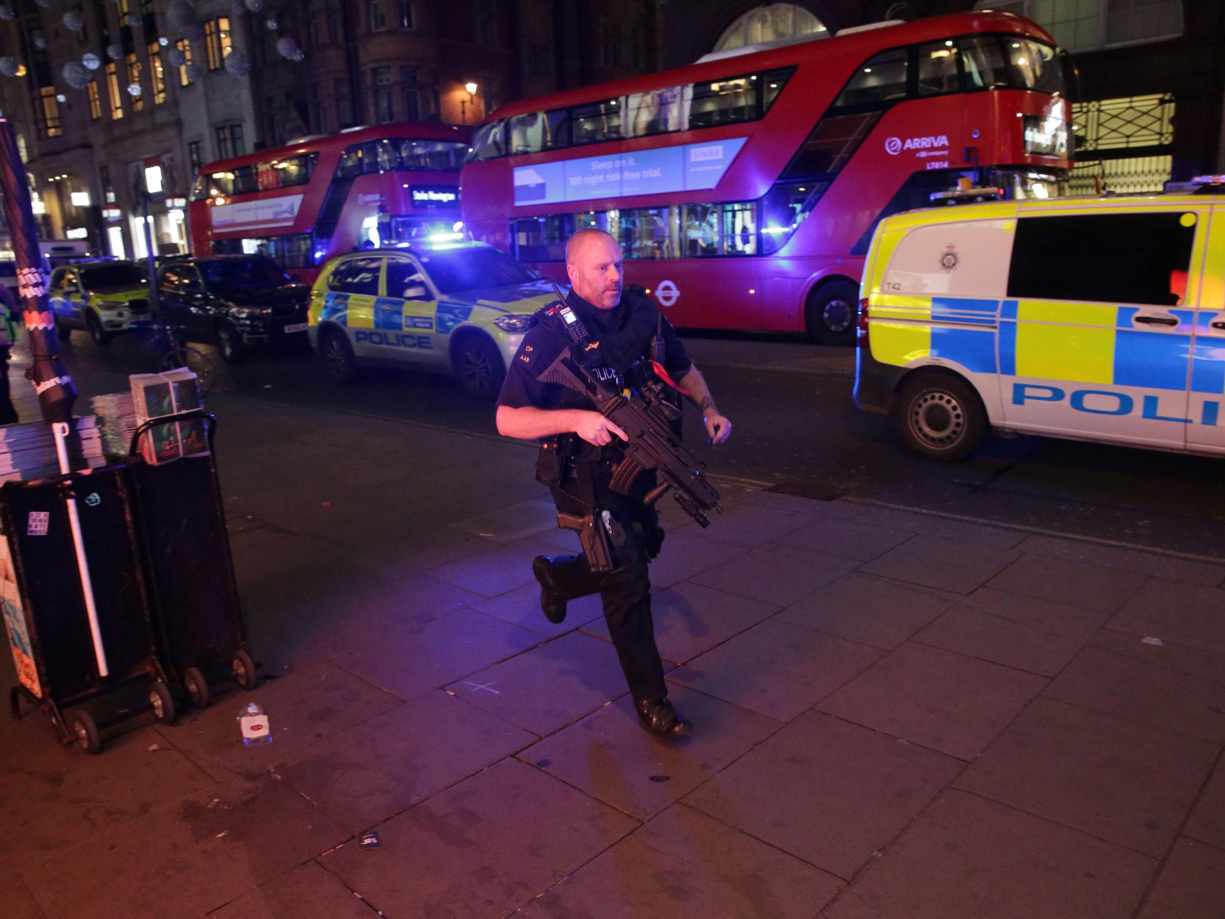 An armed policeman runs down Oxford Street in central London on November 24, 2017, as police responded to an incident
