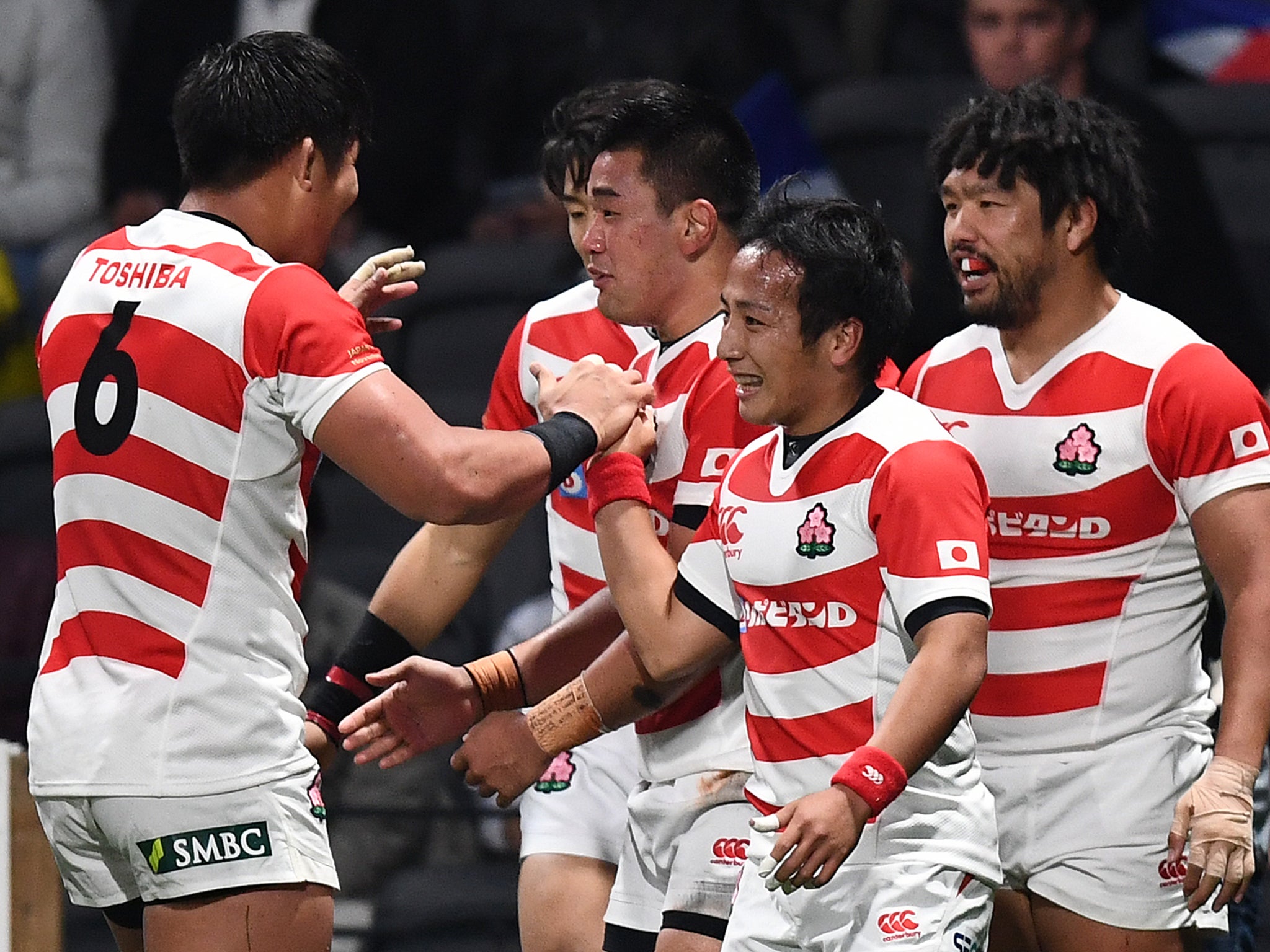 Japan celebrate after Shota Horie crosses for a try