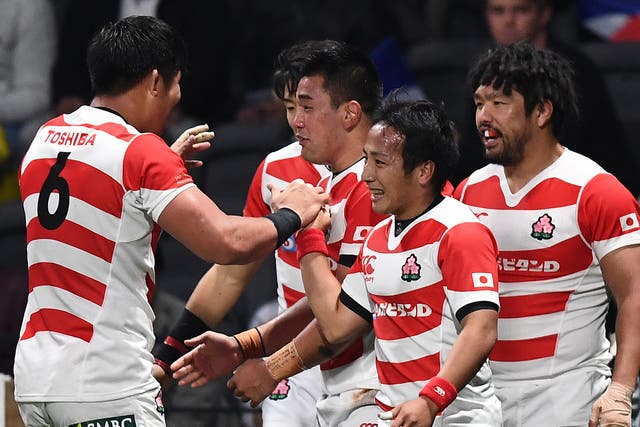 Japan celebrate after Shota Horie crosses for a try