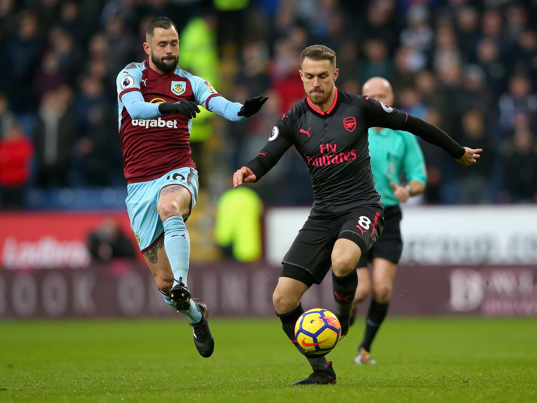 Aaron Ramsey takes on Steven Defour during Arsenal's clash with Burnley