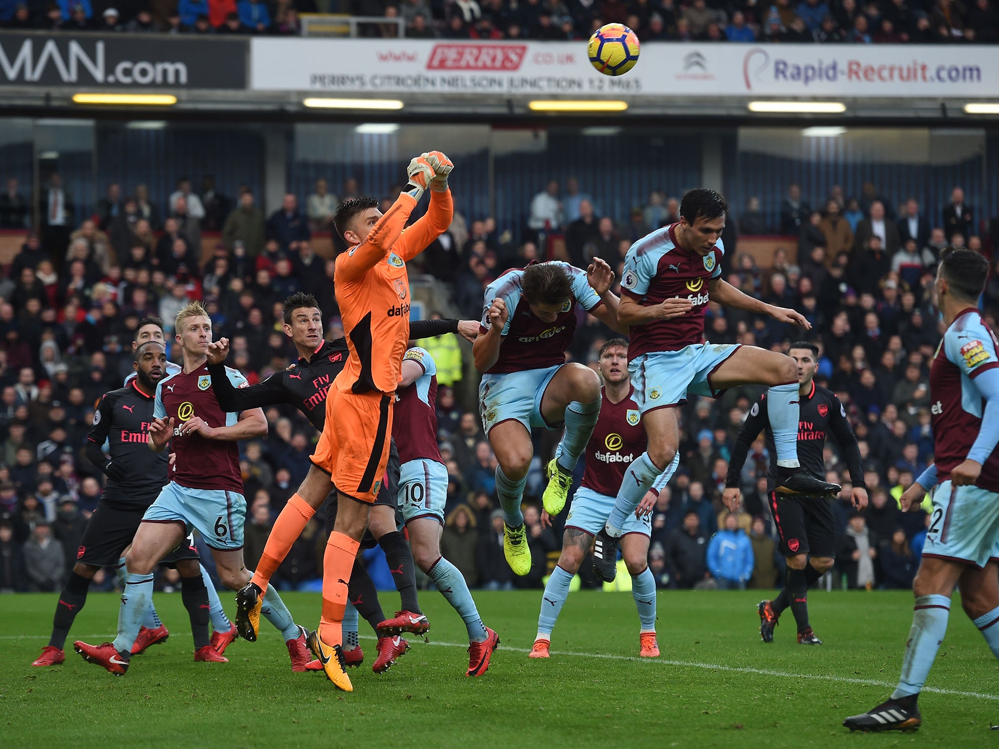 Nick Pope punches the ball clear from the Burnley area