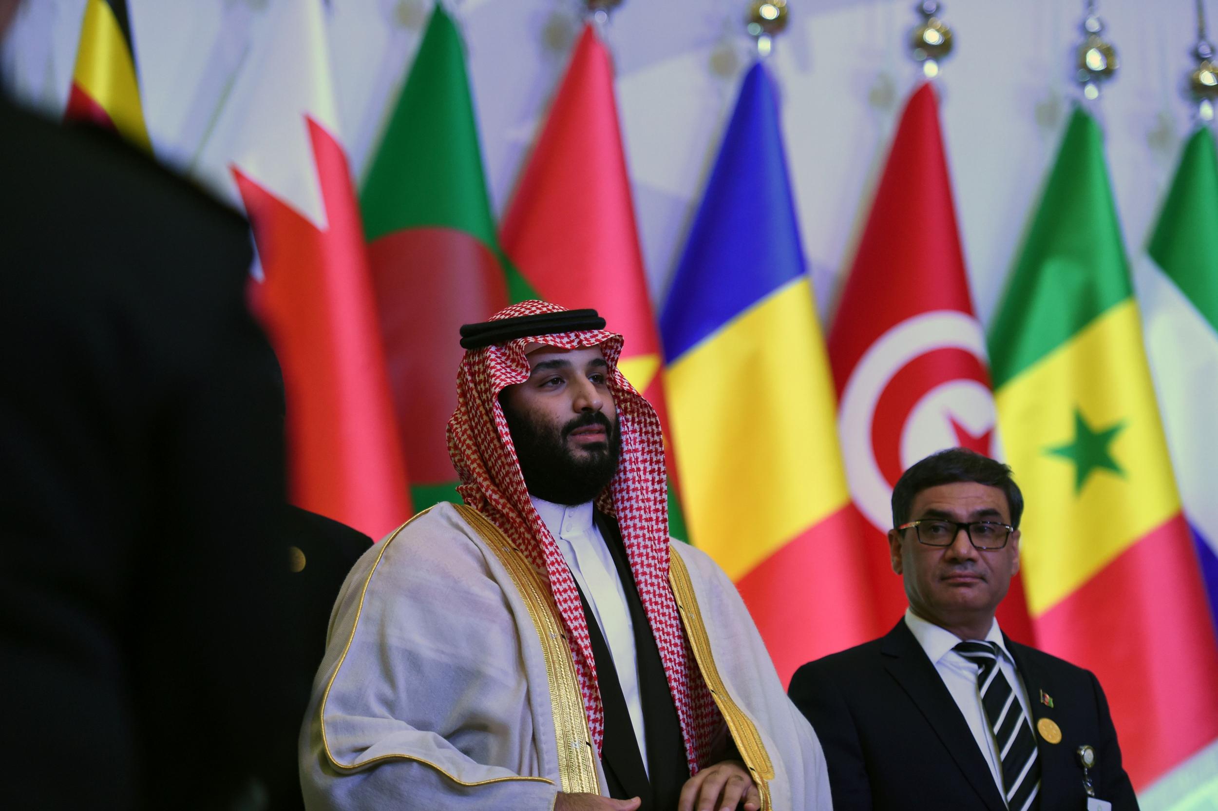 Saudi Crown Prince and Defence Minister Mohammed bin Salman (C) poses for a group picture with other defence ministers and officials of the 41-member Saudi-led Muslim counter-terrorism alliance in the capital Riyadh on 27 November 2017