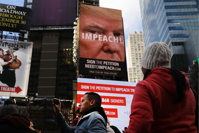 A billboard in Times Square, funded by Tom Steyer, calls for the impeachment of President Donald Trump on 20 November 2017 in New York City.
