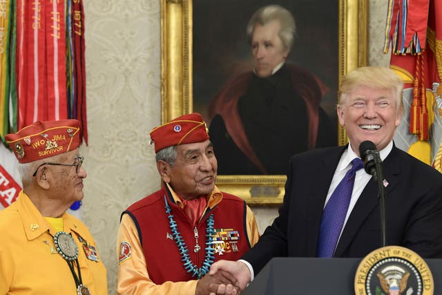 President Donald Trump, right, meets with Navajo Code Talkers Peter MacDonald, center, and Thomas Begay, left, in the Oval Office