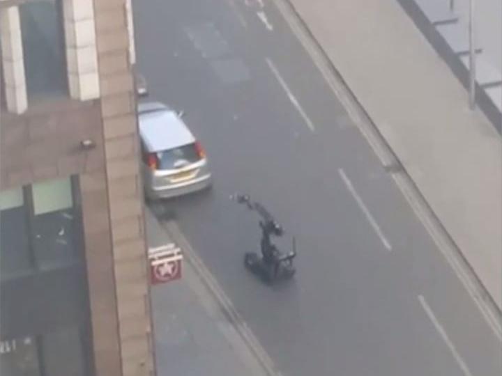 A remote bomb disposal unit investigates a car parked outside the Gherkin