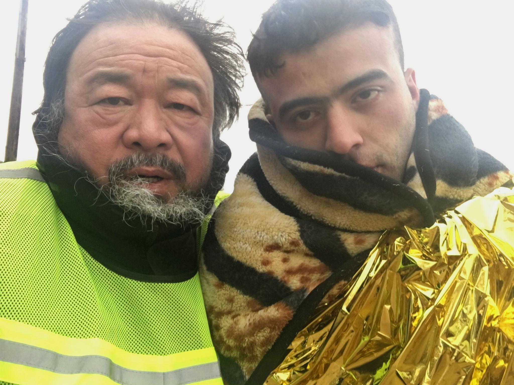 The artist and filmmaker Ai Weiwei with a refugee on the island of Lesbos in Greece for his film 'Human Flow'