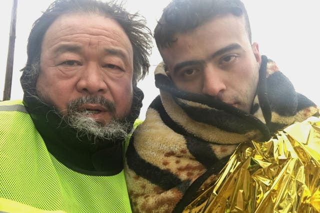 The artist and filmmaker Ai Weiwei with a refugee on the island of Lesbos in Greece for his film 'Human Flow'