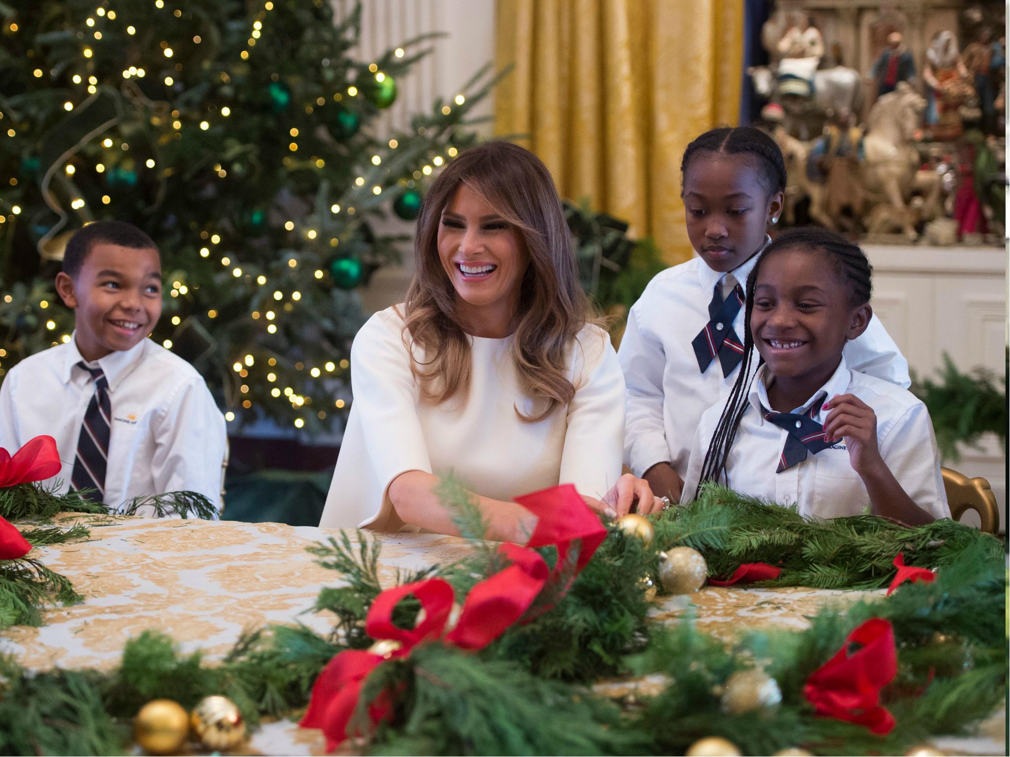 US First Lady Melania Trump makes garlands with children in the East Wing as she tours holiday decorations at the White House 27 November 2017.