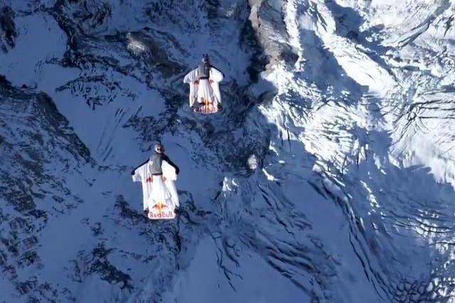 Two wingsuit flyers jump from Jungfrau mountain in Switzerland into moving plane