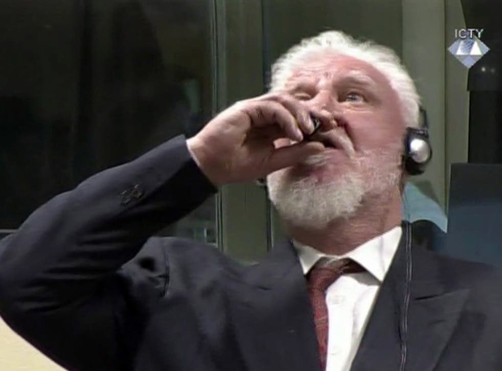 Slobodan Praljak brings a bottle to his lips during a Yugoslav War Crimes Tribunal in The Hague, after shouting: ‘I am not a war criminal’