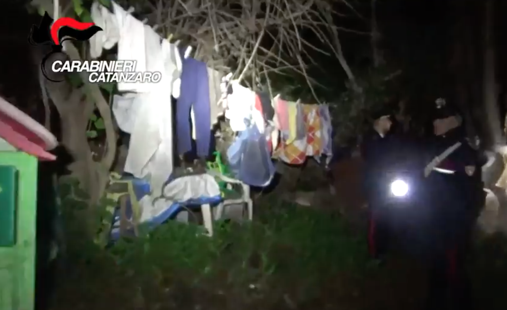 &#13;
Police footage shows washing and rubbish strewn outside the cabin (Carabinieri Catanzaro)&#13;