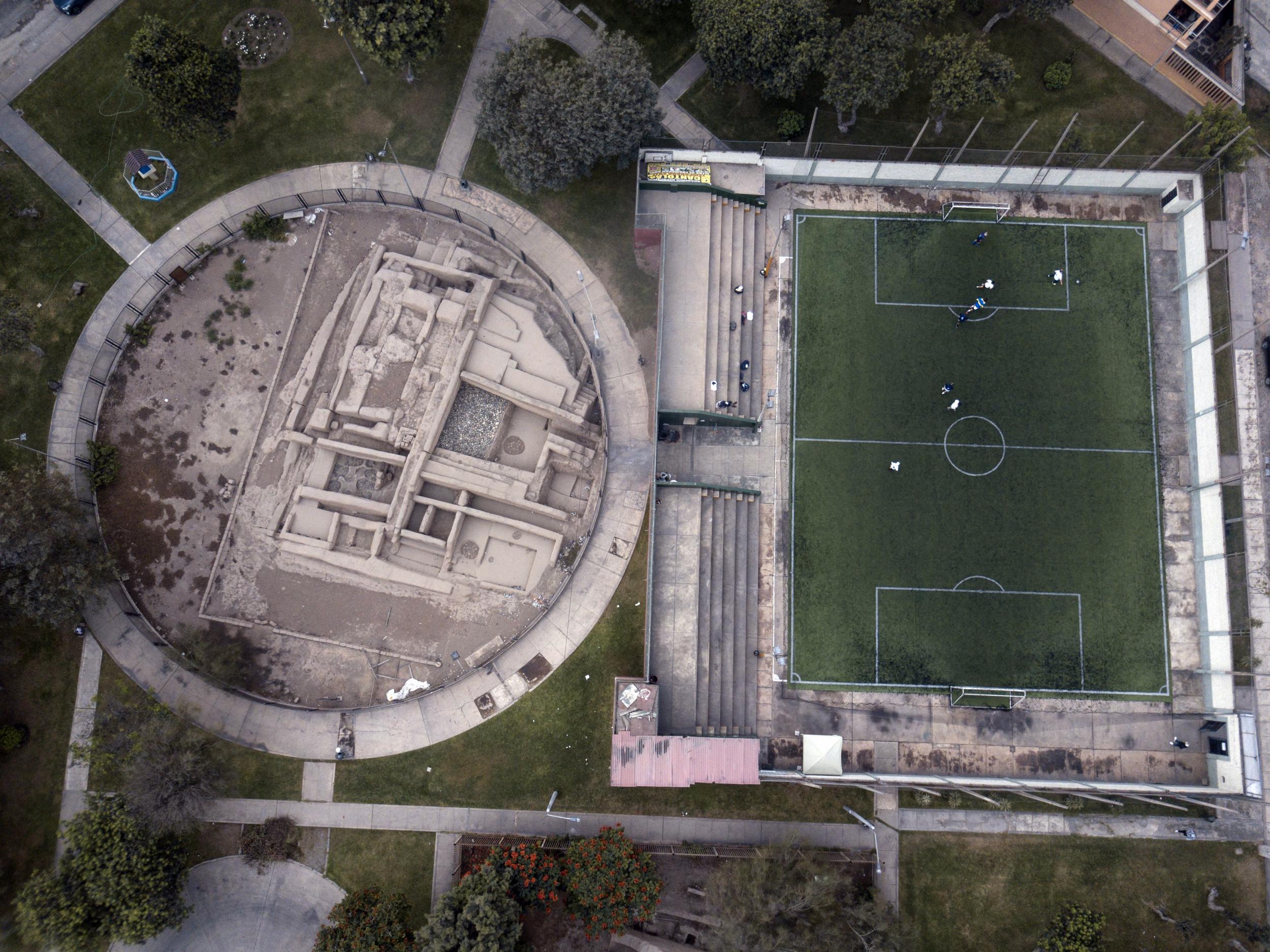 Pre-Columbian archeological site La Luz is flanked by a private soccer field players rent in Lima, Peru