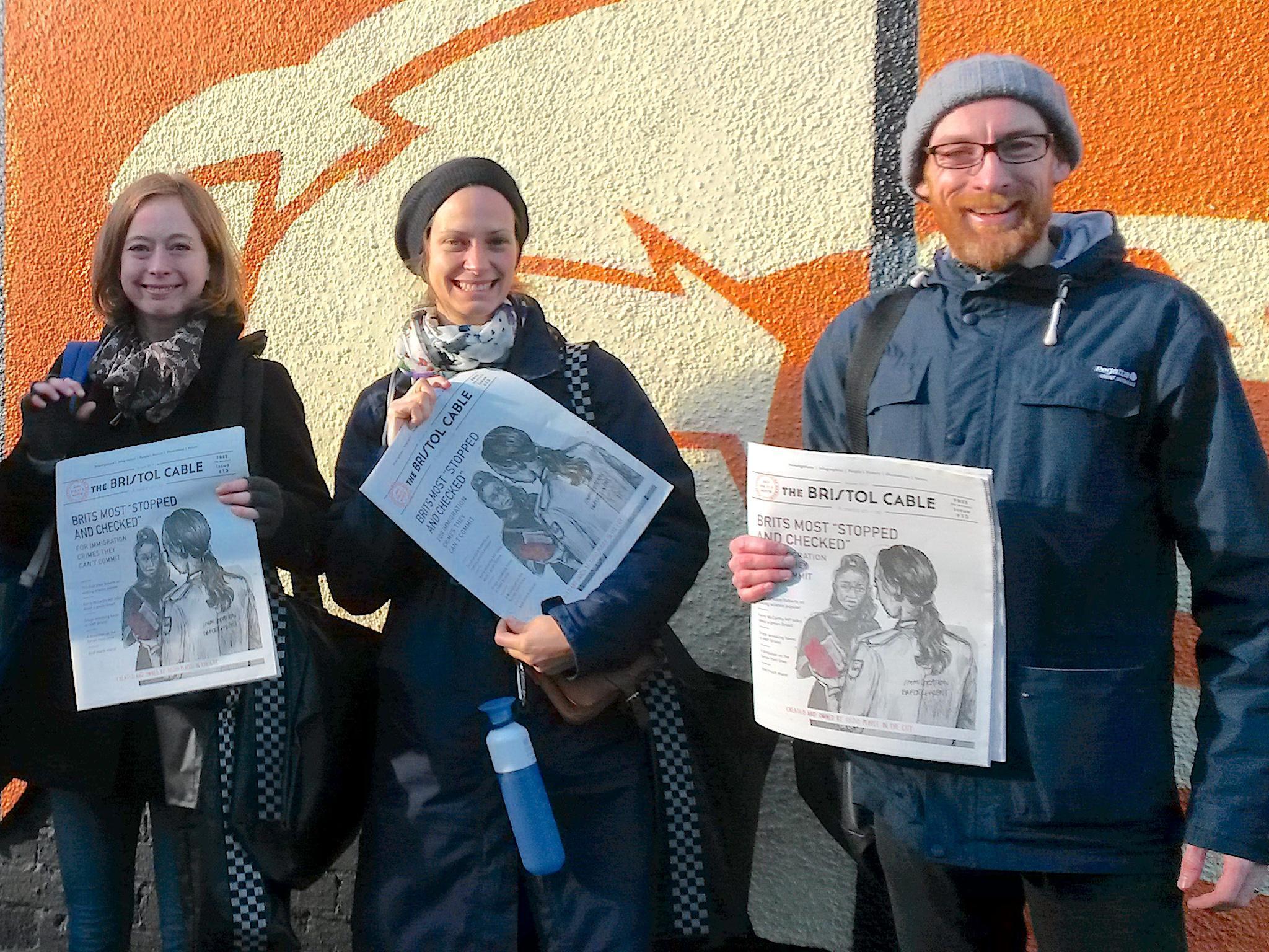 Bristol Cable members distribute an issue of the paper featuring an investigation into immigration checks