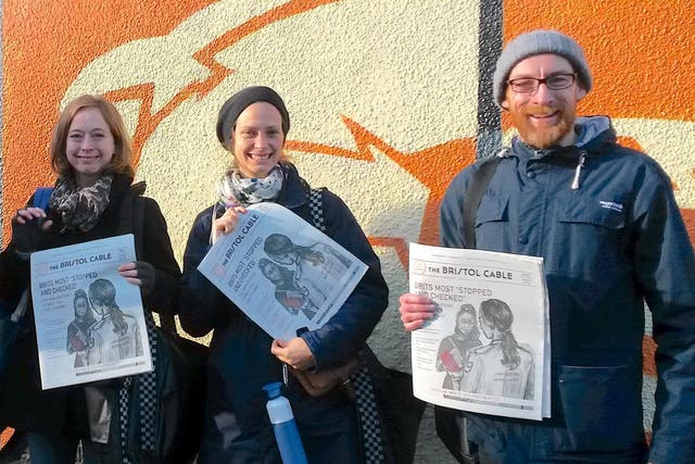 Bristol Cable members distribute an issue of the paper featuring an investigation into immigration checks 