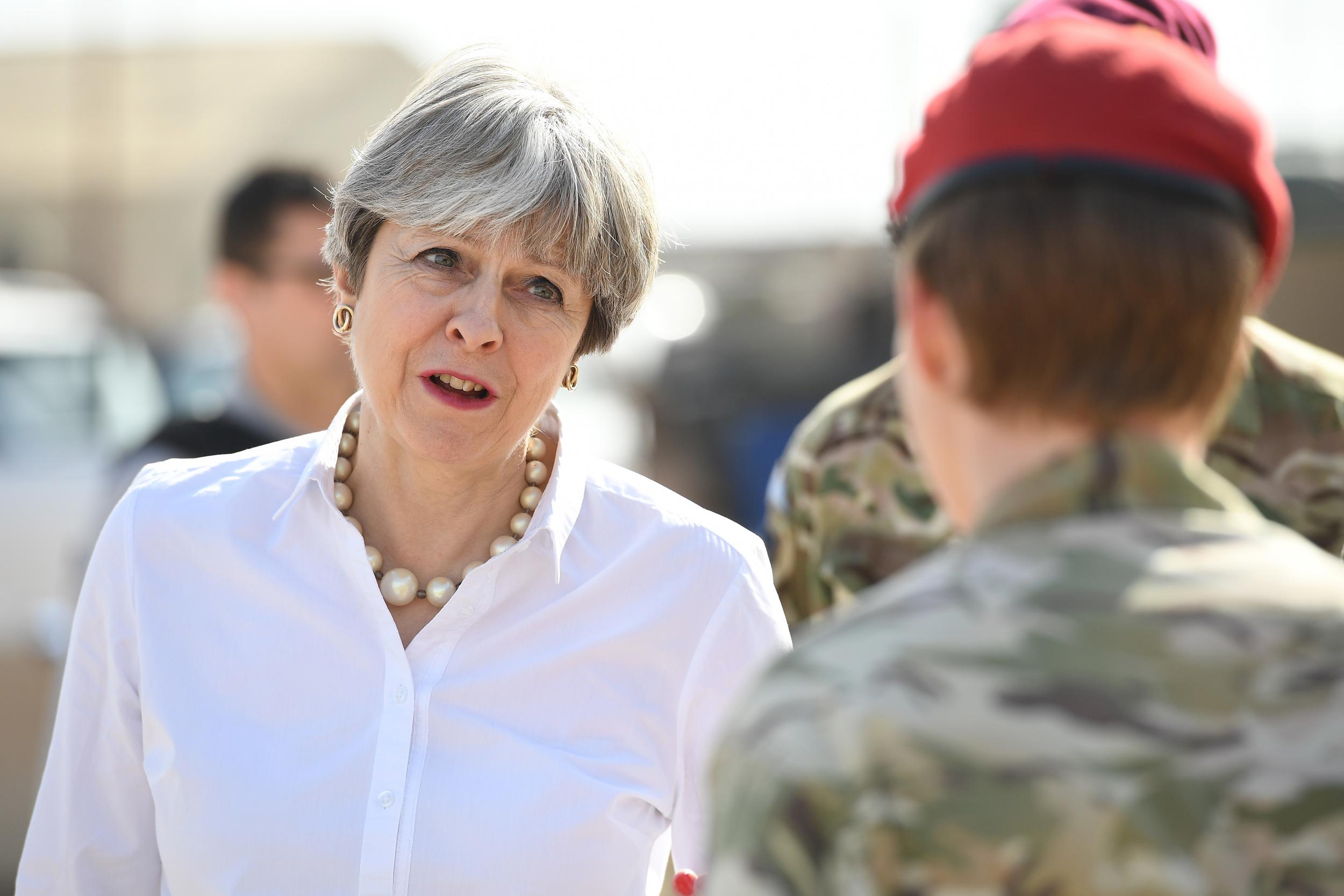 Theresa May speaks with British soldiers at the Camp Taji military base on November 29, 2017 in Taji, Iraq