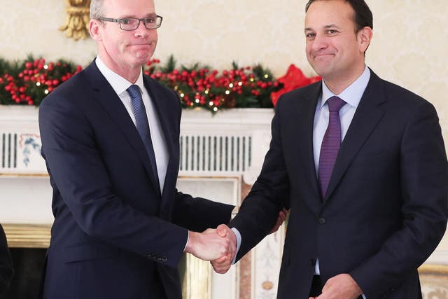 Simon Coveney shakes hands with Leo Vardkar after his appointment as Deputy Premier