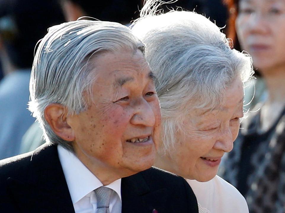 Emperor Akihito, flanked by Empress Michiko, greets guests during the annual autumn garden party at the Akasaka Palace imperial garden in Tokyo on 9 November