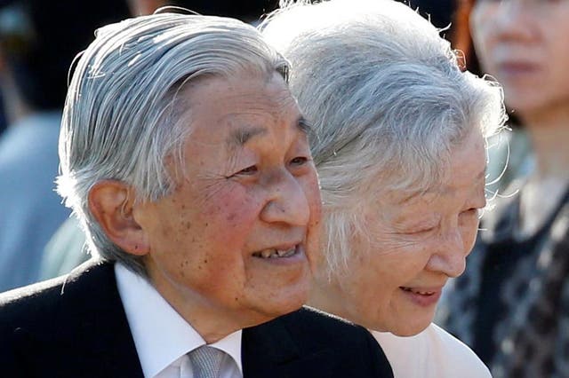 Emperor Akihito, flanked by Empress Michiko, greets guests during the annual autumn garden party at the Akasaka Palace imperial garden in Tokyo on 9 November