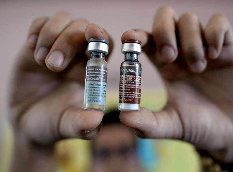 A nurse shows vials of the dengue vaccine Dengvaxia, developed by French medical giant Sanofi Pasteur, at an elementary school in Manila