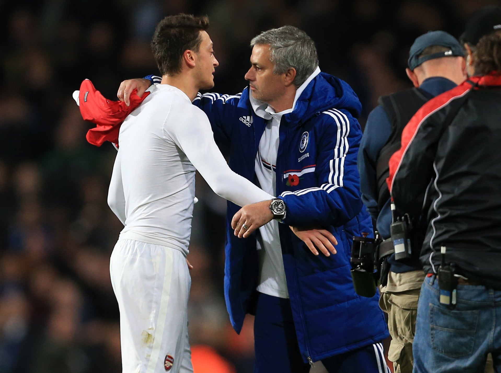 Ozil and Mourinho embrace after a League Cup game in October 2013