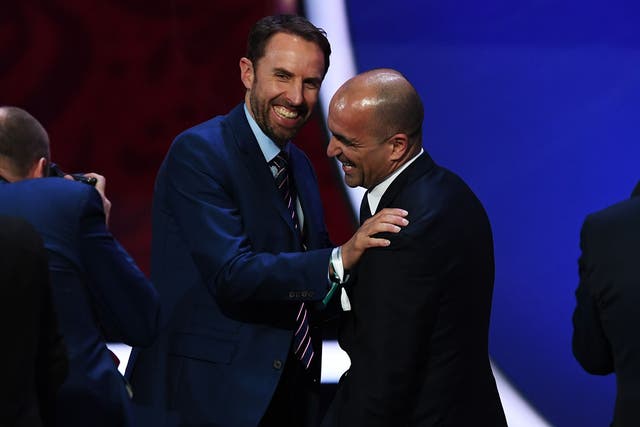 England manager, Gareth Southgate, jokes with Belgium manager, Roberto Martinez, after their sides were drawn in the same group during the Final Draw for the 2018 FIFA World Cup in Russia