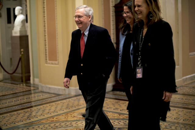 US Senate Majority Leader Mitch McConnell walks to the Senate floor as debate wraps up over the Republican tax reform plan