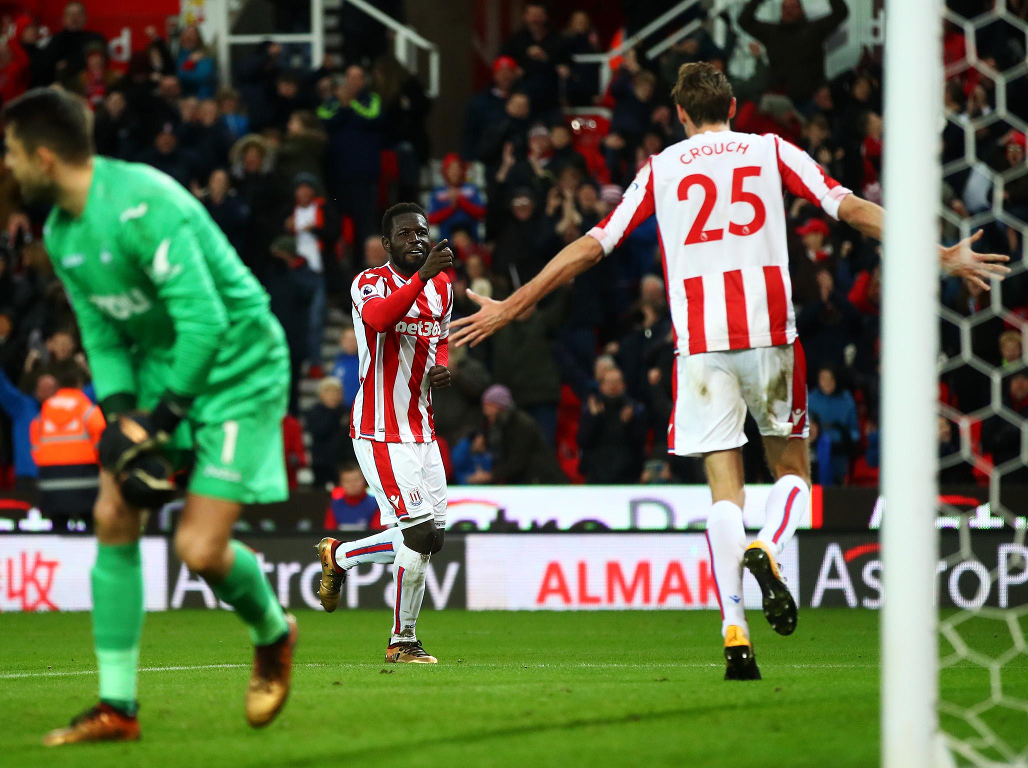 Diouf celebrates with Crouch after Stoke's equaliser